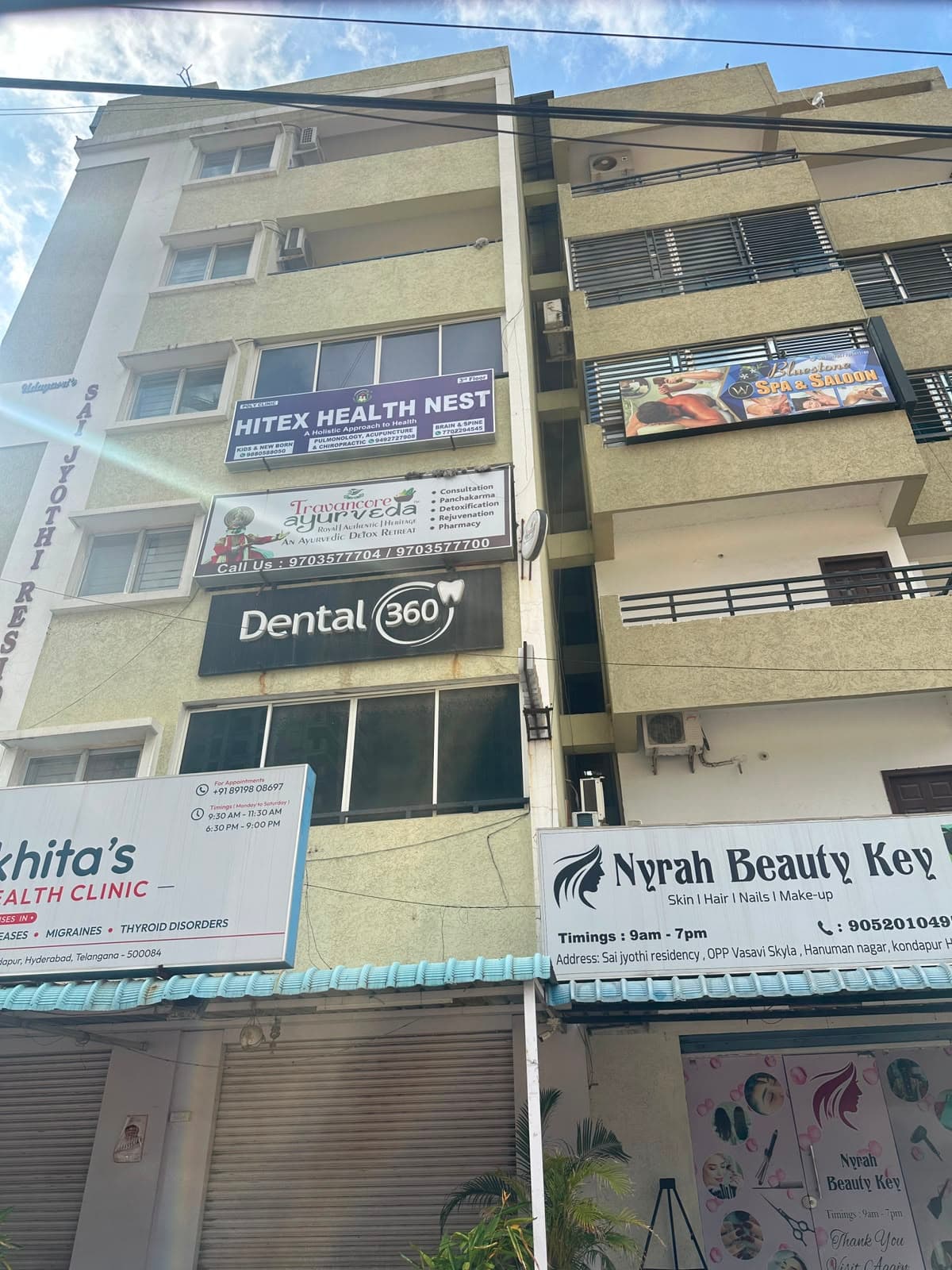 The Sai Jyothi Residency building from the main road, with the Hitex Health Nest board on the third floor