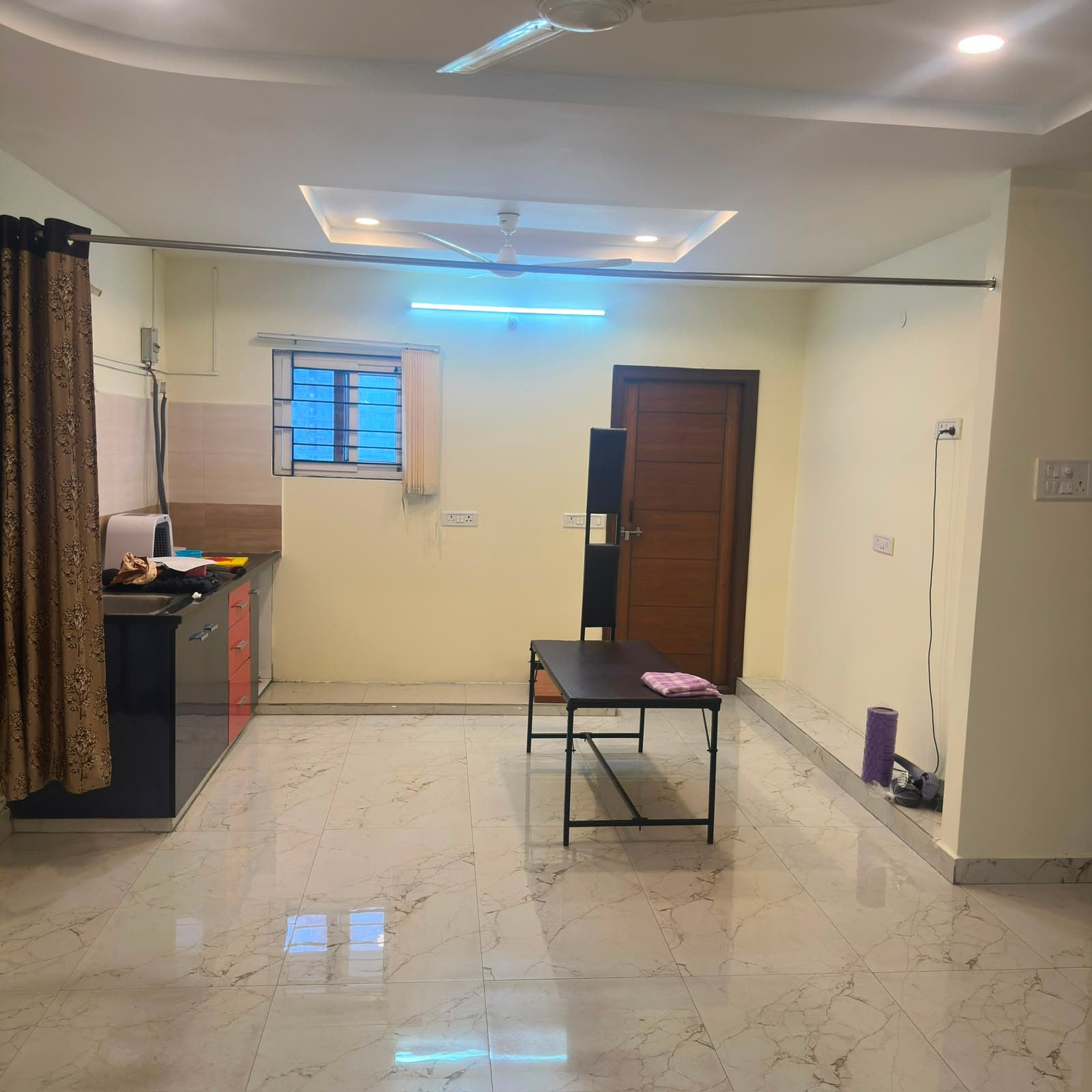 Therapy room at Hitex Health Nest with a treatment table on marble flooring